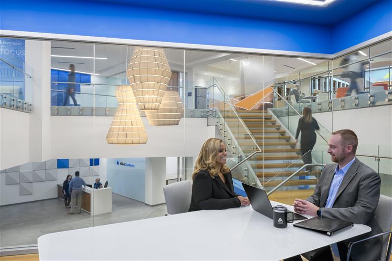 Allied employees stand, discussing available products and services